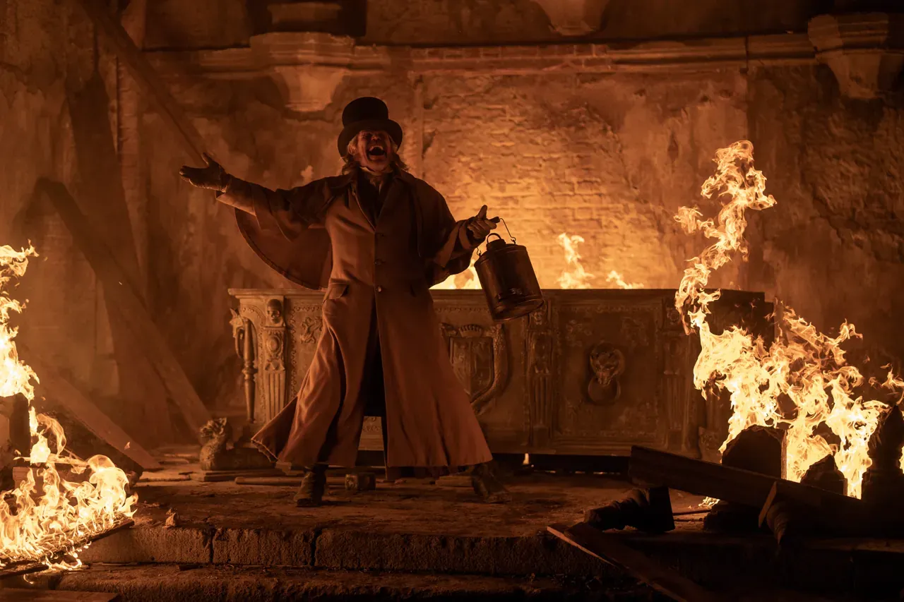 Willem Dafoe standing before a burning altar in the film Nosferatu